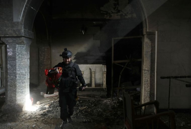 a-christian-iraqi-special-forces-soldier-walks-in-a-newly-liberated-church-in-bartella-east-of-mosul