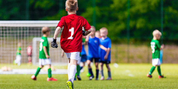 web3-children-boy-soccer-field-green-red-jersey-shutterstock