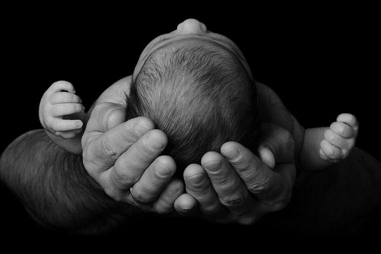 baby_in_parents_arms_credit_geliatida_shutterstock_cna