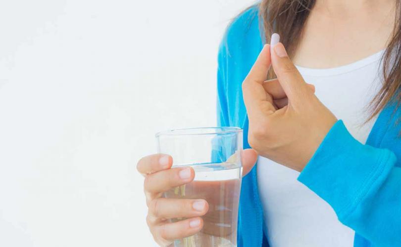 abortion-pill-woman-blue-sweater_810_500_75_s_c1