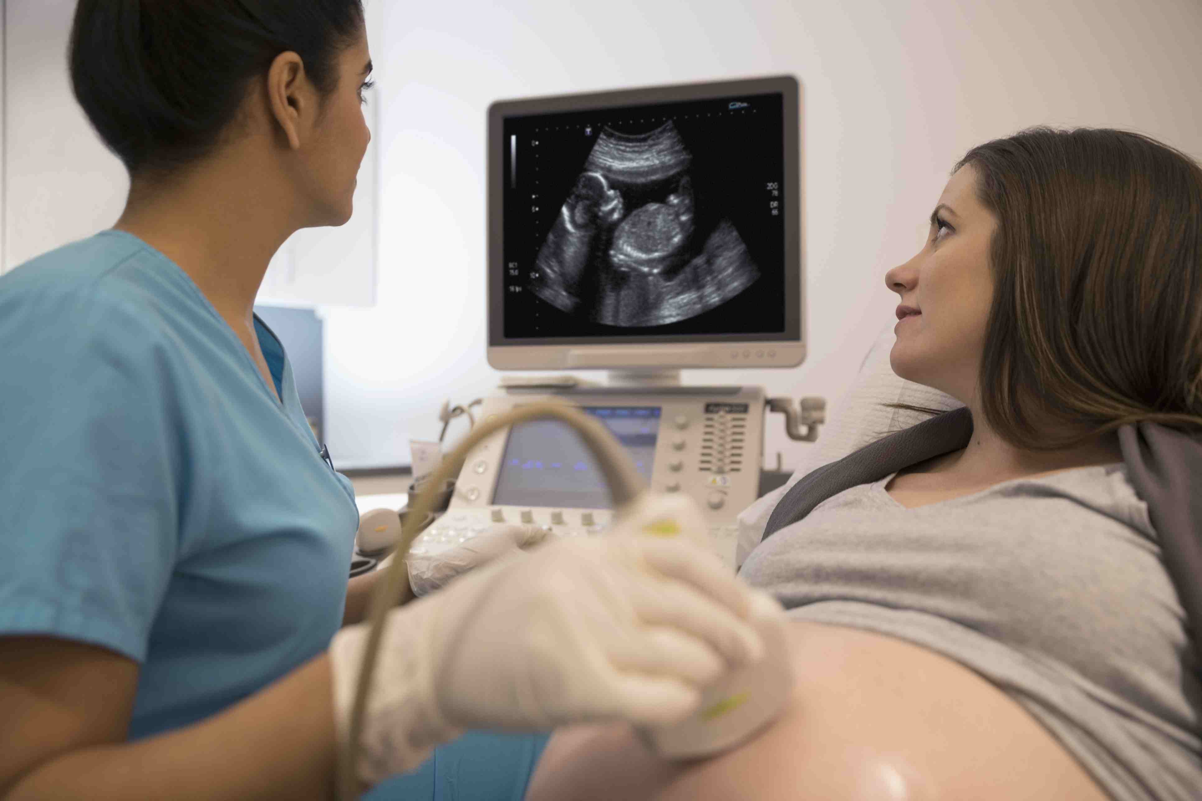 female-nurse-performing-ultrasound-on-pregnant-woman-in-examination-room-697537711-5bff19cfc9e77c0051c989fc