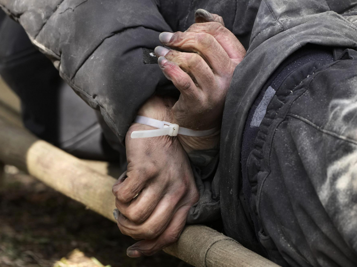 a_dead_civilian_with_his_hands_tied_behind_his_back_lies_on_the_ground_in_bucha